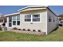 Charming home exterior with well-maintained lawn and landscaping creating an inviting curb appeal at 662 Sinclair Cir, Tavares, FL 32778