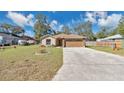 Charming single-story home with a two-car garage and a well-maintained front yard at 905 Ida St, Wildwood, FL 34785