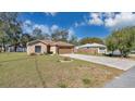 Single-Gathering home with a well-manicured lawn and a two-car garage at 905 Ida St, Wildwood, FL 34785