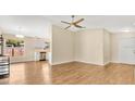 Bright living room with wood floors, neutral walls, with kitchen view at 905 Ida St, Wildwood, FL 34785