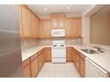 Bright kitchen with light wood cabinets and stainless steel appliances at 980 Crestwood Commons Ave, Ocoee, FL 34761