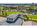 Community aerial view showcases amenities with playground, lush landscapes, and luxury residential houses at 1015 Jack Nicklaus Ct, Kissimmee, FL 34747