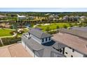 Elevated aerial view of homes highlighting community amenities, serene landscaping, and manicured lawns at 1015 Jack Nicklaus Ct, Kissimmee, FL 34747
