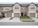 Three-story townhome building with attached garages and well-maintained landscaping at 1021 Pavia Dr, Apopka, FL 32703