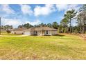 Lovely single-story home with a spacious front yard, inviting curb appeal at 12 Pecan Drive Loop, Ocala, FL 34472