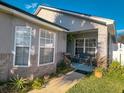 Welcoming front porch with decorative plants and a cozy seating area at 2609 Summer Creek Dr, Kissimmee, FL 34747