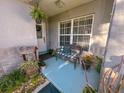 Inviting porch featuring plants and a bench, leading to the home's entrance at 2609 Summer Creek Dr, Kissimmee, FL 34747