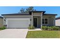 Newly built home with a two-car garage and a modern facade at 2896 Lingo Ln, Orlando, FL 32822