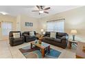 Living room with tiled floors, brown couches, and a coffee table at 3071 Beach Palm Ave, Kissimmee, FL 34747