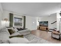 Bright living room with modern decor, a large sectional, and hardwood floors at 3104 Harrison Ave # 11, Orlando, FL 32804