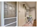 Inviting porch with tile floor, seating, and view through a screen door at 3104 Harrison Ave # 11, Orlando, FL 32804