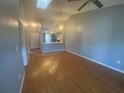 Open-concept living room featuring hardwood floors, vaulted ceiling, and lots of natural light at 4709 Almond Willow Dr, Orlando, FL 32808