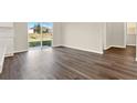 Spacious living area featuring vinyl plank flooring and access to backyard at 5531 Hayloft Dr, Apopka, FL 32712