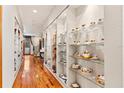 Long hallway with built-in glass display shelves at 5800 N Dean Rd, Orlando, FL 32817