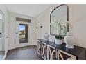 Bright and airy entryway with a stylish console table and mirror at 5816 Galloping Dr, Apopka, FL 32712