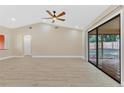 Spacious living room with high ceilings, new flooring, ceiling fan and large sliding glass doors to backyard at 605 Marni Dr, Winter Springs, FL 32708