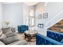 Bright living room with vaulted ceiling, modern furniture, and beautiful flooring at 8130 Yellow Crane Dr, Kissimmee, FL 34747