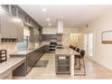 Stylish kitchen with granite countertops, stainless steel appliances, and ample cabinet space at 933 Southern Oak Ln, Apopka, FL 32712