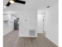 Open-concept living area with wood-look flooring, leading into kitchen at 1211 Dorothy St, Lakeland, FL 33815