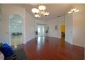 Spacious living room with hardwood floors, decorative archways, and bright, natural lighting at 1332 Hunterman Lane, Winter Garden, FL 34787