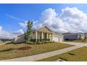 Well-kept home displaying a manicured lawn, fresh landscaping, and a welcoming three car garage at 14436 Topaghan Way, Winter Garden, FL 34787