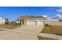 Attractive single-Gathering home boasting a three-car garage, well-maintained lawn, and inviting curb appeal at 14436 Topaghan Way, Winter Garden, FL 34787