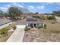 Aerial view showcasing the home's layout, landscaping and neighborhood at 1523 Whooping Dr, Groveland, FL 34736