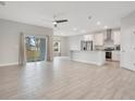 Open floor plan with kitchen island, stainless steel appliances, and tile floors at 2011 Begonia Way, Poinciana, FL 34759