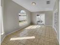 Spacious living area with tile floors and access to backyard at 203 San Gabriel St, Winter Springs, FL 32708
