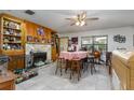 Inviting dining room with tile floors, stone fireplace, and built-in shelves at 2357 Palm Way, Oviedo, FL 32765