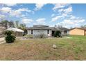 Charming single-story home with stone accents, mature landscaping, and a covered carport at 2357 Palm Way, Oviedo, FL 32765