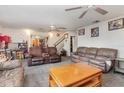 Comfortable living room with neutral tones, ceiling fans, and carpet flooring at 2357 Palm Way, Oviedo, FL 32765