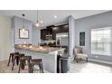 Modern kitchen with granite counters, stainless steel appliances, and breakfast bar at 3097 Pequod Pl, Kissimmee, FL 34746