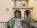 Welcoming entrance to a townhome with a gated walkway and a charming covered porch at 5381 Via Appia Way, Sanford, FL 32771