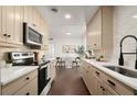 Bright kitchen with updated stainless steel appliances, sleek countertops and stylish hardwood flooring at 608 S Oxalis Ave, Orlando, FL 32807