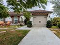 Two-car garage with light taupe doors and a stone facade at 124 Hollyhock Ct, Kissimmee, FL 34743