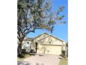 Well-maintained single-story home with a two-car garage and brick-paved driveway at 124 Lancaster Dr, Davenport, FL 33897