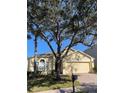 House exterior showcasing a two-car garage and landscaping at 124 Lancaster Dr, Davenport, FL 33897