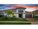 Charming single-story home featuring a tile roof, meticulously landscaped yard, and an attached two-car garage at 13265 Alderley Dr, Orlando, FL 32832