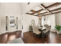 Elegant dining room featuring wood floors, high ceilings, a decorative ceiling, and elegant lighting at 13596 Gorgona Isle Dr, Windermere, FL 34786