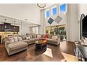 Spacious living room featuring wood floors, high ceilings, lots of windows, and an open floor plan at 13596 Gorgona Isle Dr, Windermere, FL 34786