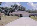 Cozy one-story home with a well-manicured lawn and a long driveway at 18148 Villa City Rd, Groveland, FL 34736