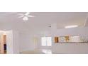 Bright living room with ceiling fan and natural light at 18148 Villa City Rd, Groveland, FL 34736