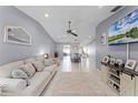 Inviting living room with a large sofa, neutral walls, and a large window offering plenty of natural light at 2214 Se Sawgrass Ct, Winter Haven, FL 33884