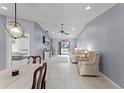 Open-concept living area showcasing neutral tones, tile floors, and a dining space at 2214 Se Sawgrass Ct, Winter Haven, FL 33884