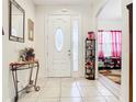 Bright entryway with tile floors, a decorative table, and an accent mirror at 2218 W Gore St, Orlando, FL 32805