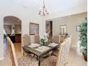 Elegant dining room with tile floors, traditional furniture, and modern decor at 2632 Sand Hill Point Cir, Davenport, FL 33837