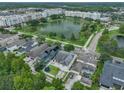 Serene aerial view of a community with a picturesque lake and well-maintained homes at 3966 Avalon Park West Blvd, Orlando, FL 32828