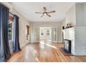 Spacious living area with hardwood floors, white brick fireplace and french doors at 404 W 19Th St, Sanford, FL 32771