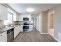 Modern kitchen with white cabinets, granite countertops, and stainless steel appliances at 424 S Observatory Dr, Orlando, FL 32835